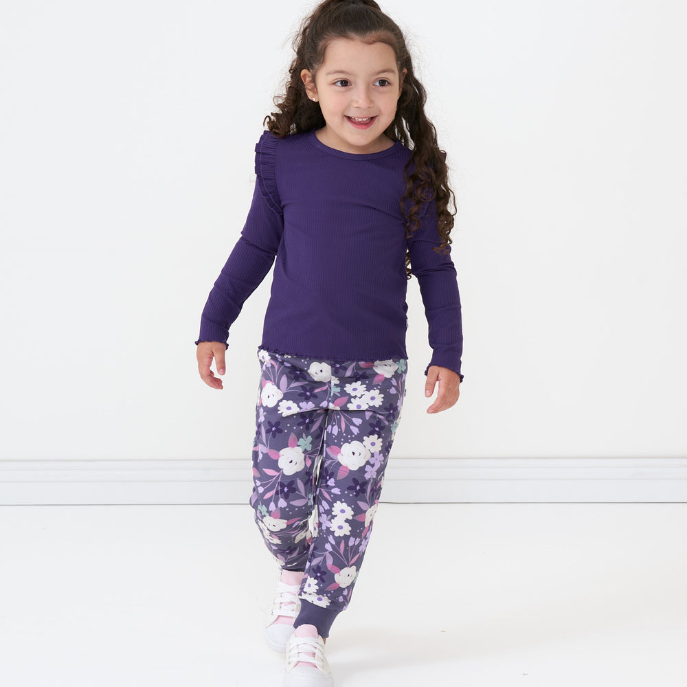 Alternate image of a child wearing Sugar Plum Floral joggers paired with a Deep Amethyst flutter lettuce tee