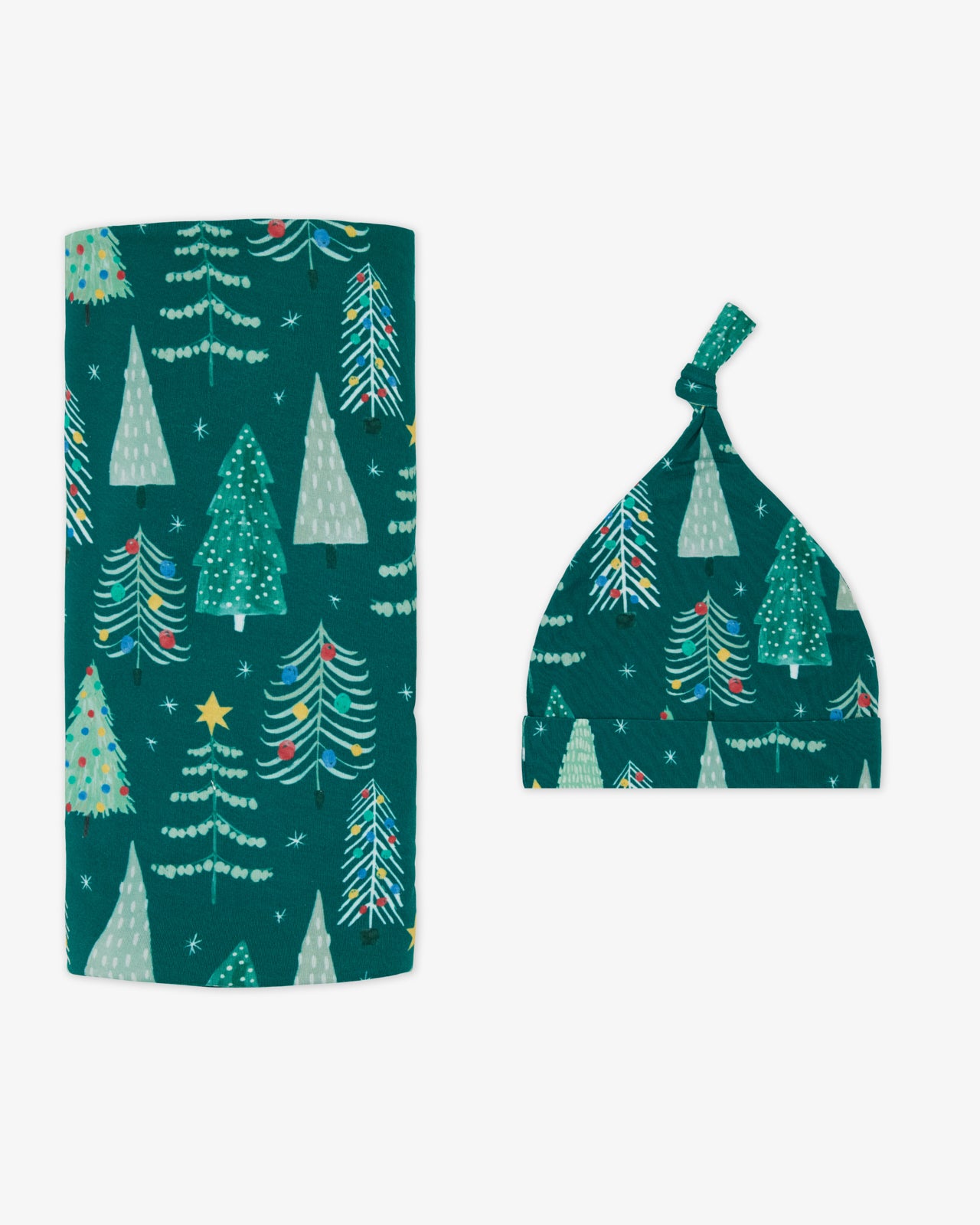 Flat lay of the Twinkling Trees Swaddle & Hat Set