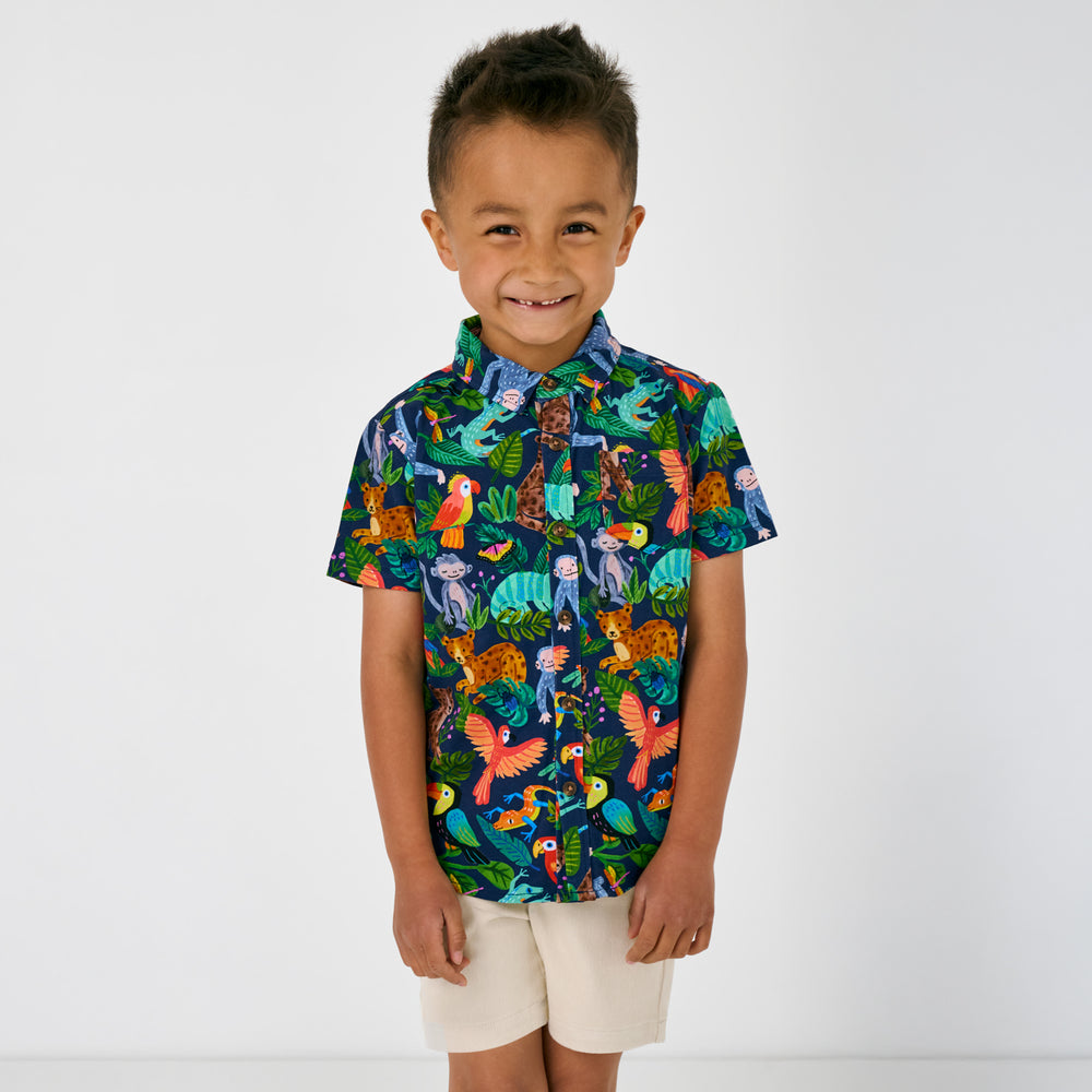 Standing child wearing the Treetop Tails Button Down Polo and chino shorts