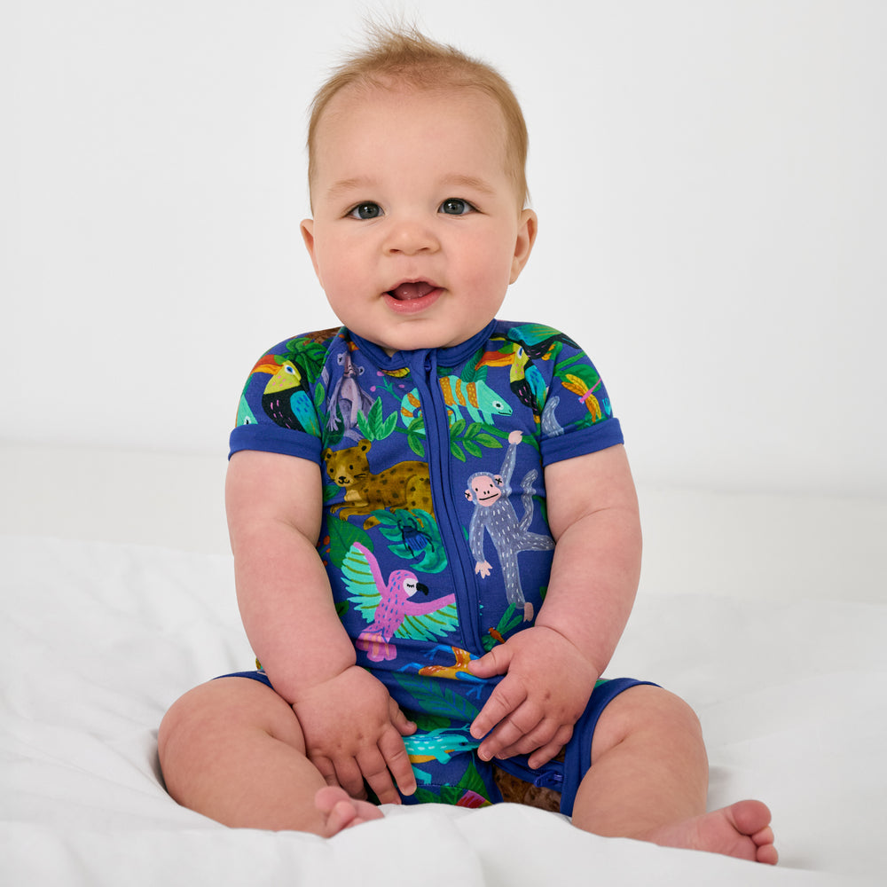 Sitting child wearing the Treetop Tails Shorty Zippy