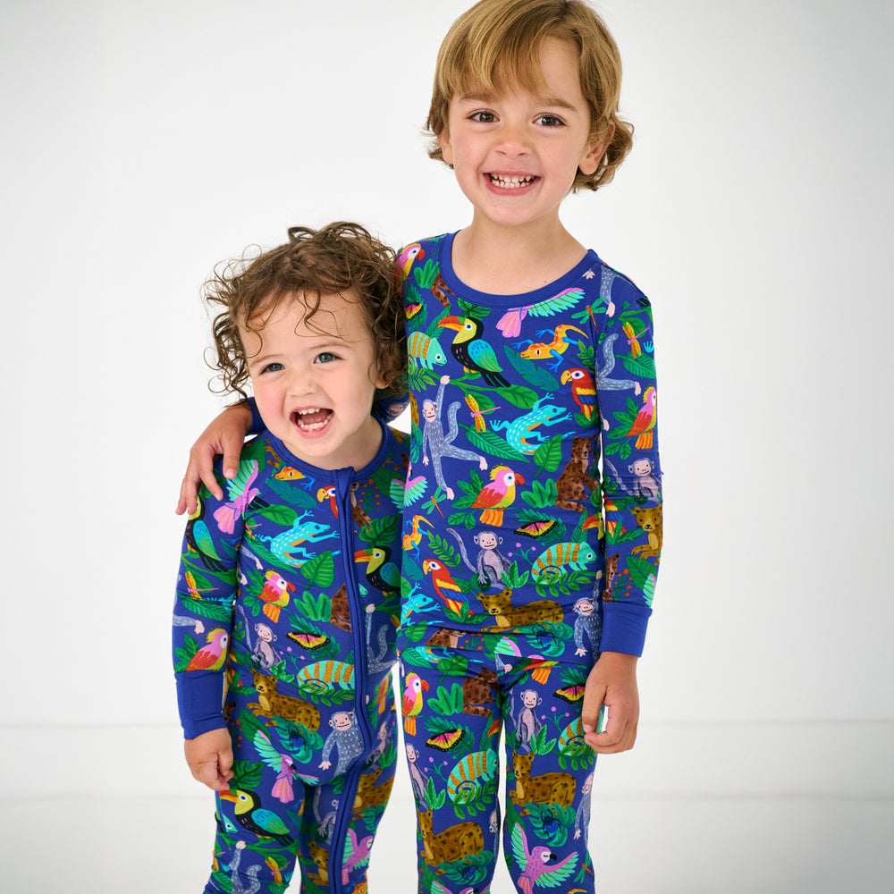 Two children wearing matching Treetop Tails Bamboo Kids Pajamas
