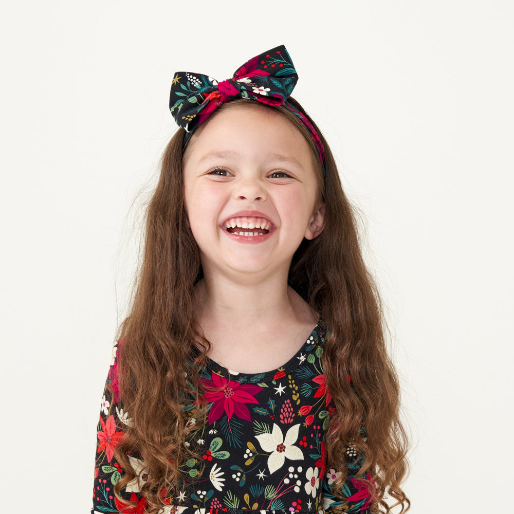 Child wearing a Berry Merry twirl dress paired with a matching Berry Merry Luxe Bow headband