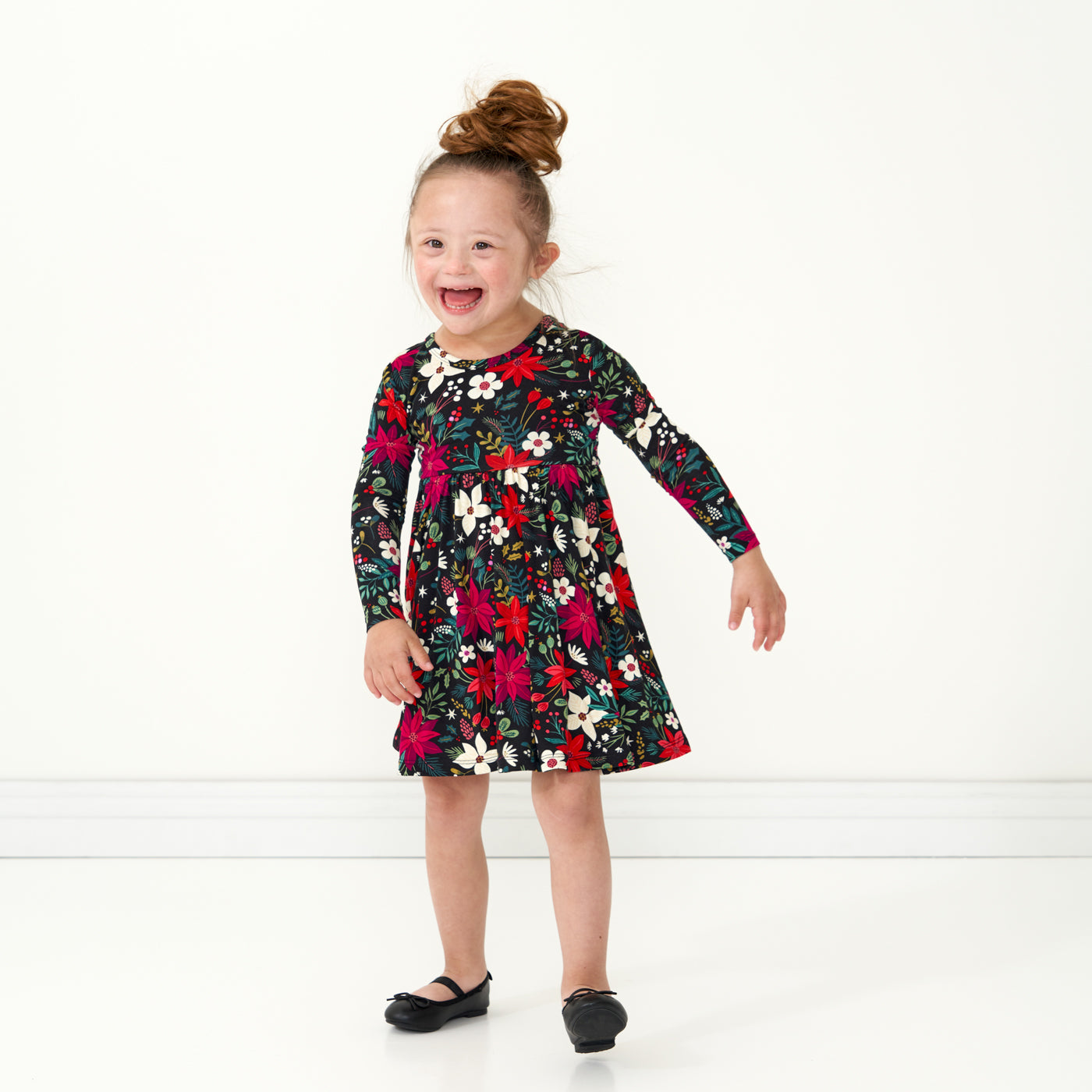Child dancing wearing a Berry Merry twirl dress with bodysuit