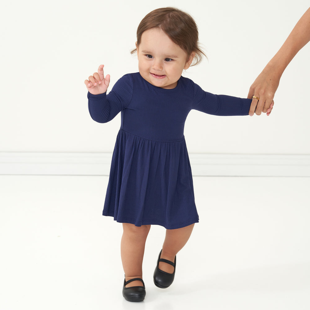 Alternate image of a child holding a parent's hand wearing a Classic Navy ribbed twirl dress with bodysuit
