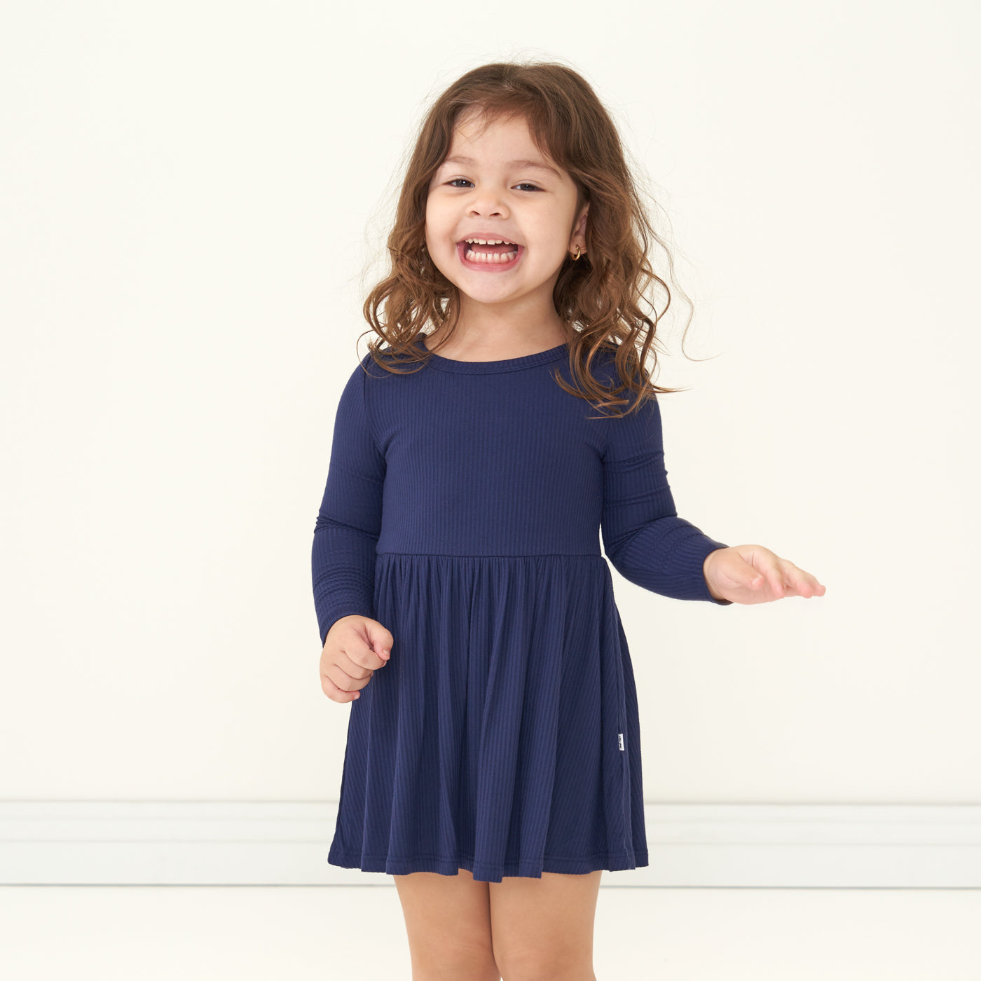 Child wearing a Classic Navy ribbed twirl dress with bodysuit