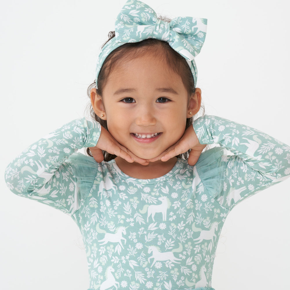 Child wearing a Unicorn Garden luxe bow headband and matching flutter tee