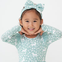Child wearing a Unicorn Garden luxe bow headband and matching flutter tee