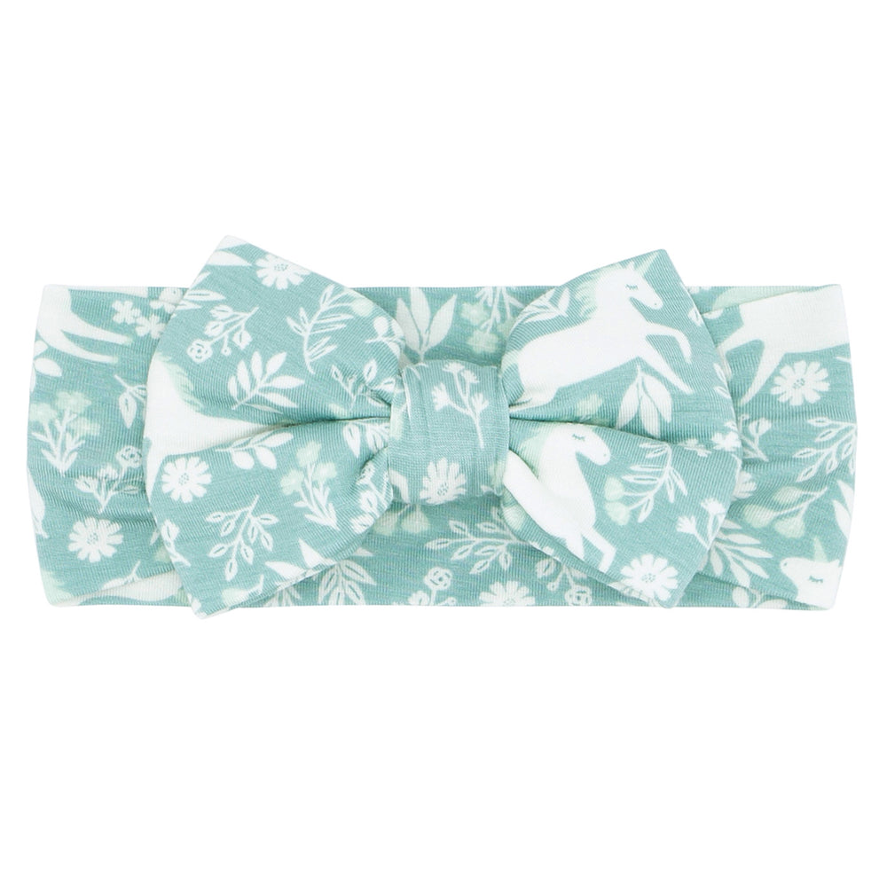 Flat lay image of a Unicorn Garden luxe bow headband