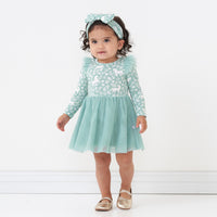 Child wearing a Unicorn Garden flutter tutu dress with bloomer and matching luxe bow headband