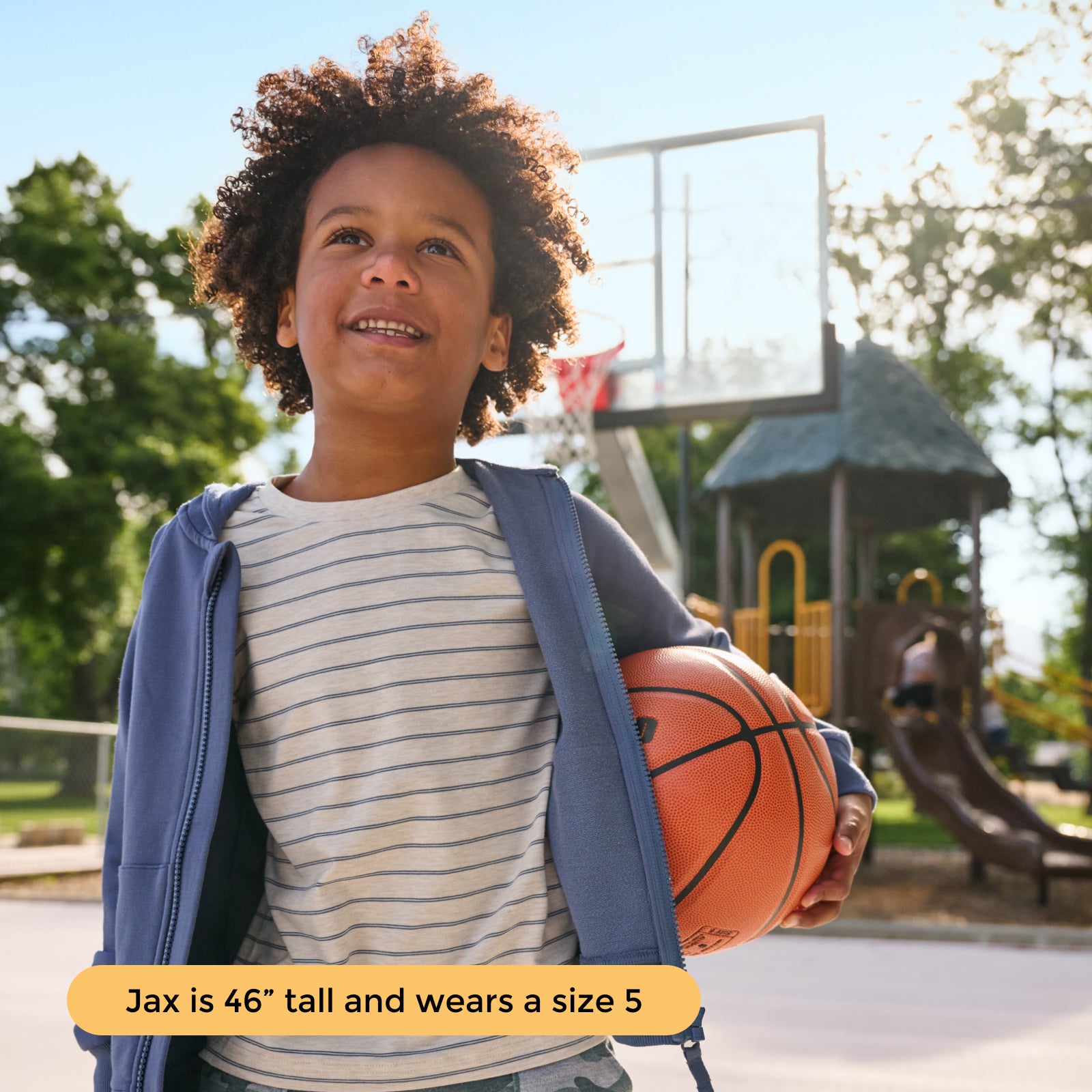 Boy holding basketball while wearing the Vintage Navy Zip Hoodie and Stone Stripe Relaxed Tee