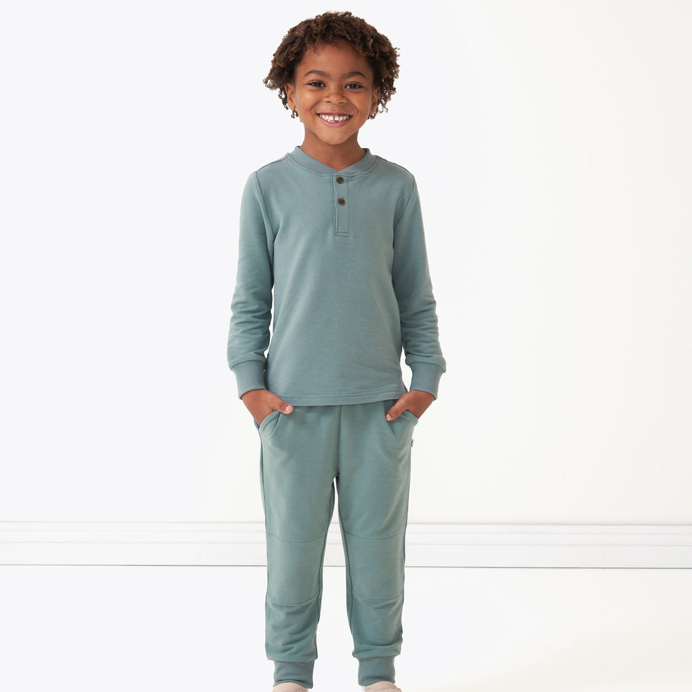 Child wearing Vintage Teal joggers and matching henley tee