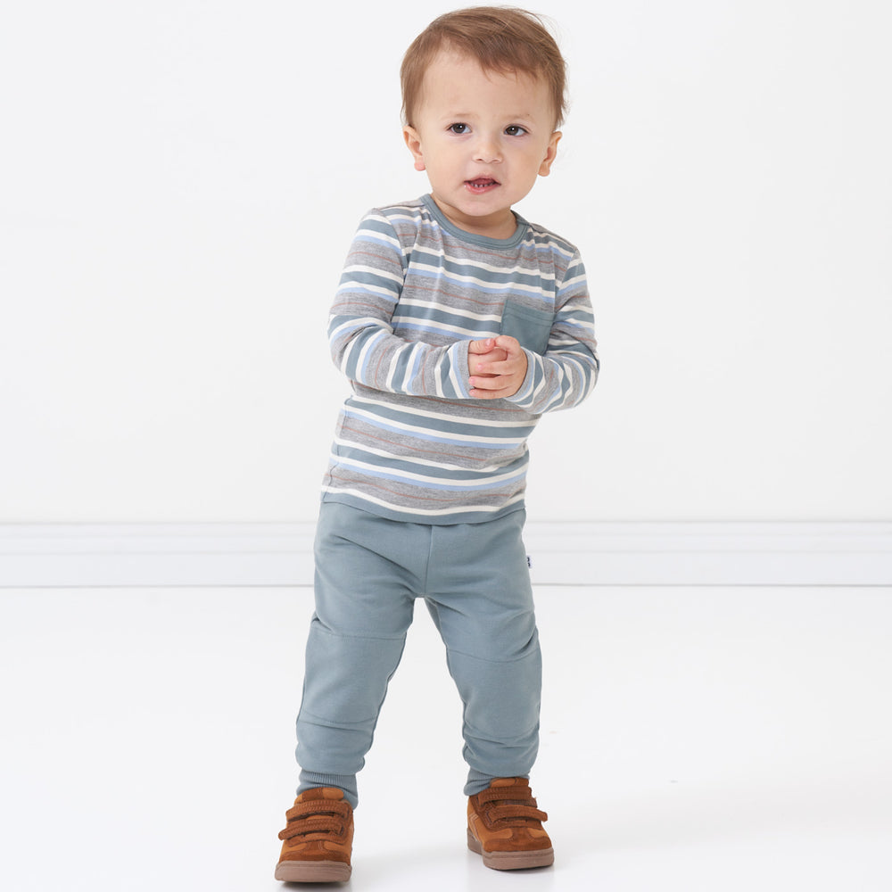 Child wearing Vintage Teal Joggers paired with a Vintage Teal Stripes pocket tee