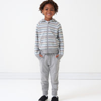Child wearing a Vintage Teal Stripes zip hoodie and coordinating heather gray joggers