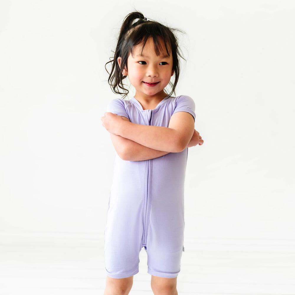 Child posing wearing a Wisteria shorty romper
