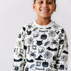 Close up image of a child wearing Witches Brew crewneck