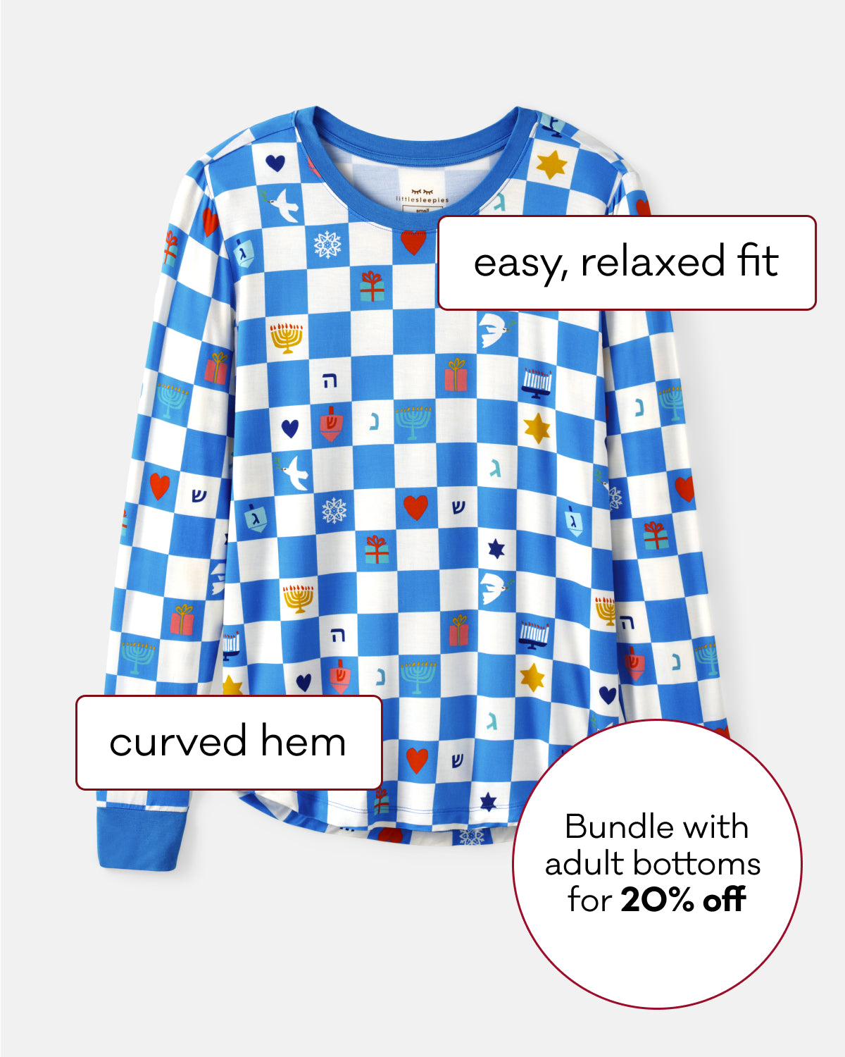 A long-sleeve top with a blue and white checkerboard pattern featuring small colorful Hanukkah symbols, shown on a light gray background with text callouts describing the fit and hem, plus a promotional badge.