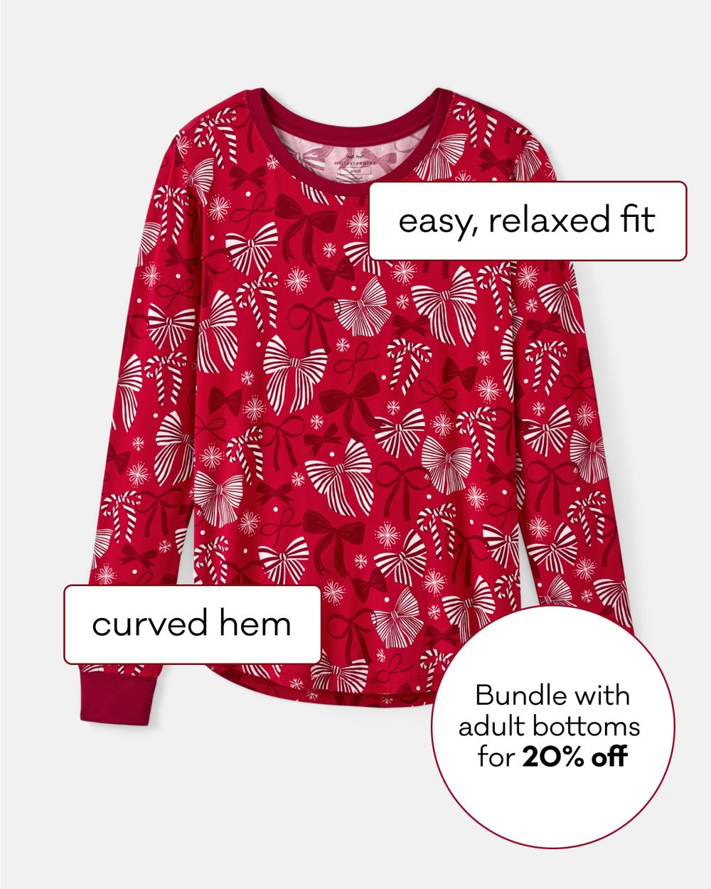 A red long-sleeve top with white and pink bows, featuring text callouts that read 'easy, relaxed fit', 'curved hem', and 'Bundle with adult bottoms for 20% off' on a light gray background.
