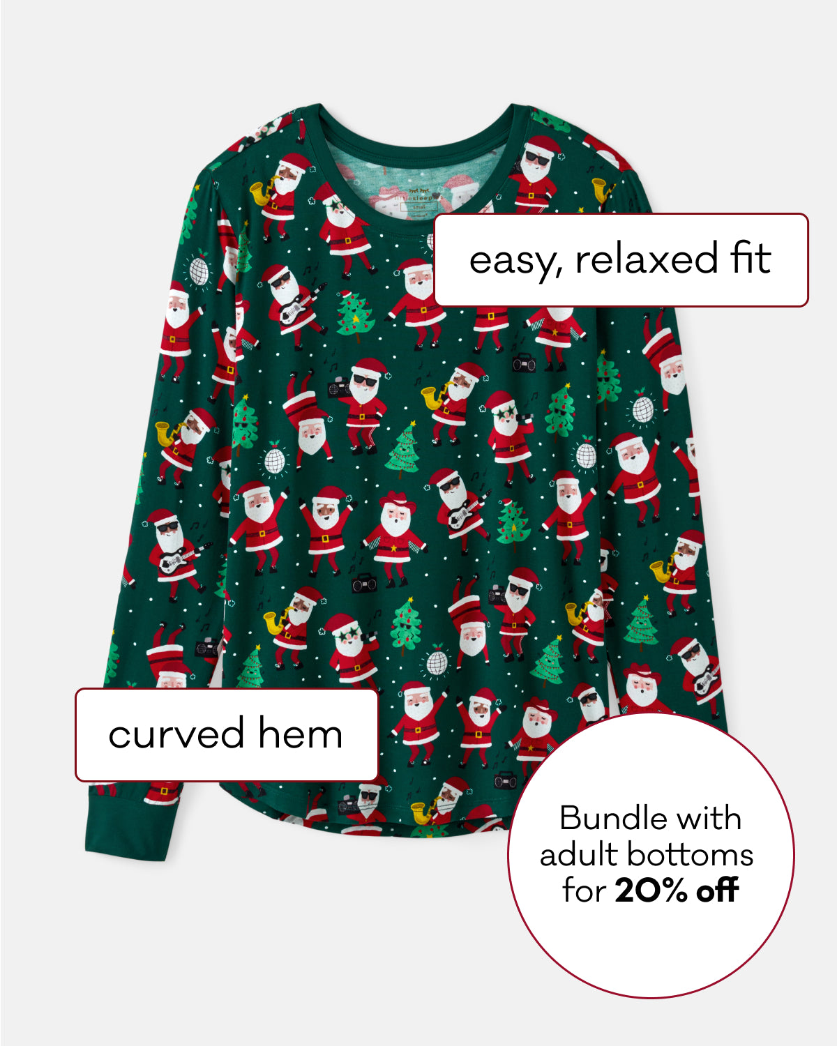 A long-sleeve Santa-themed pajama top with a green background and an all-over print of Santa Claus, trees, and snowflakes. White text labels point out features like 'easy, relaxed fit' and 'curved hem,' with a promotional circle offering a bundle with adult bottoms for 20% off.