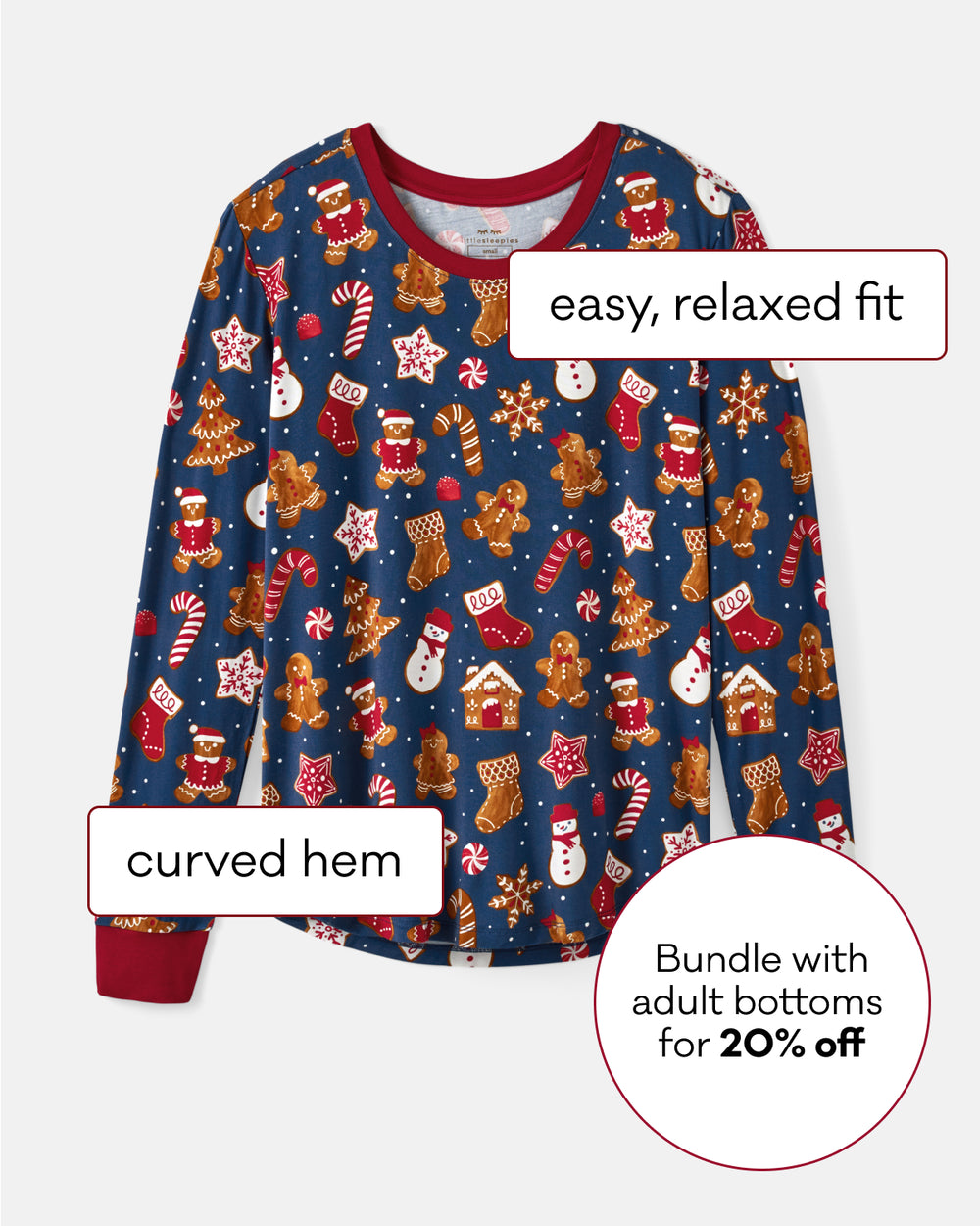 A long-sleeve pajama top with a navy blue base and an all-over print of gingerbread houses, candy canes, snowmen. The image includes text callouts highlighting features like 'easy, relaxed fit', 'curved hem', and a promotional offer for an adult bottoms bundle.