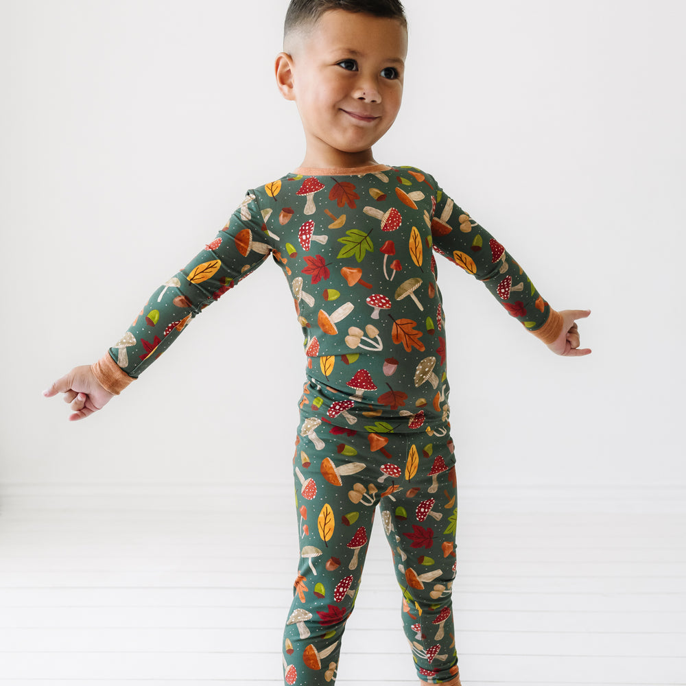 Child with their arms spread out wearing a Woodland Forest two-piece pajama set