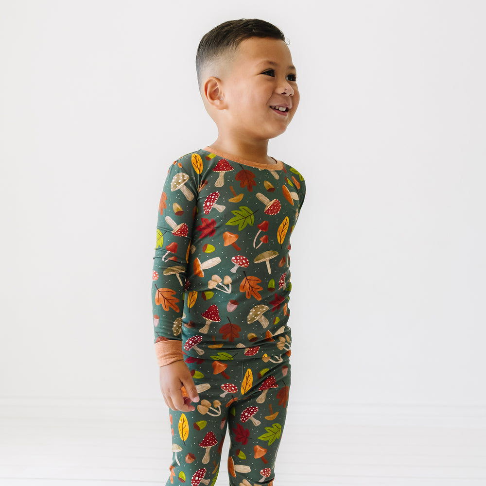 Child looking to the side wearing a Woodland Forest two-piece pajama set