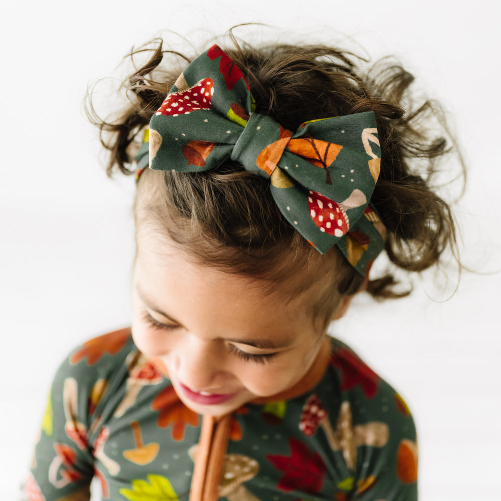Alternate close up image of a child wearing a Woodland Forest luxe bow headband