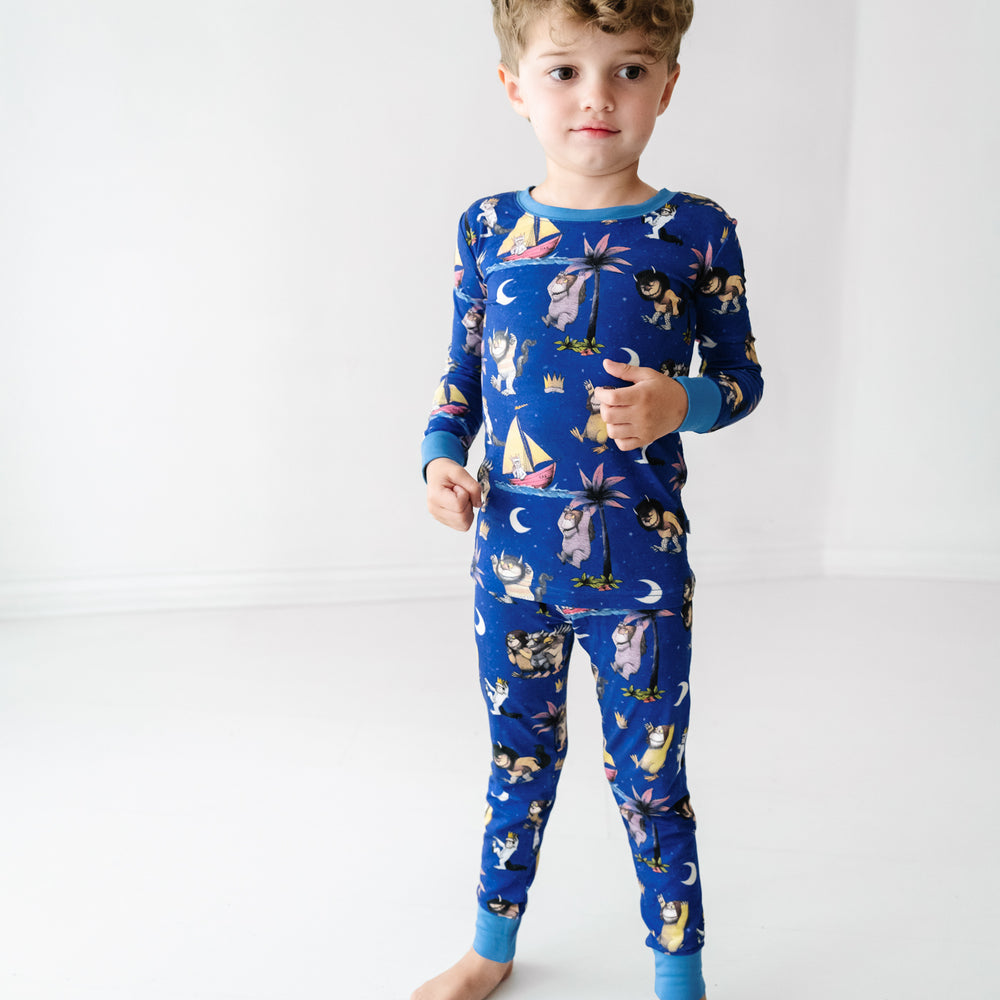 Child posing wearing a Where the Wild Things Are two piece pajama set