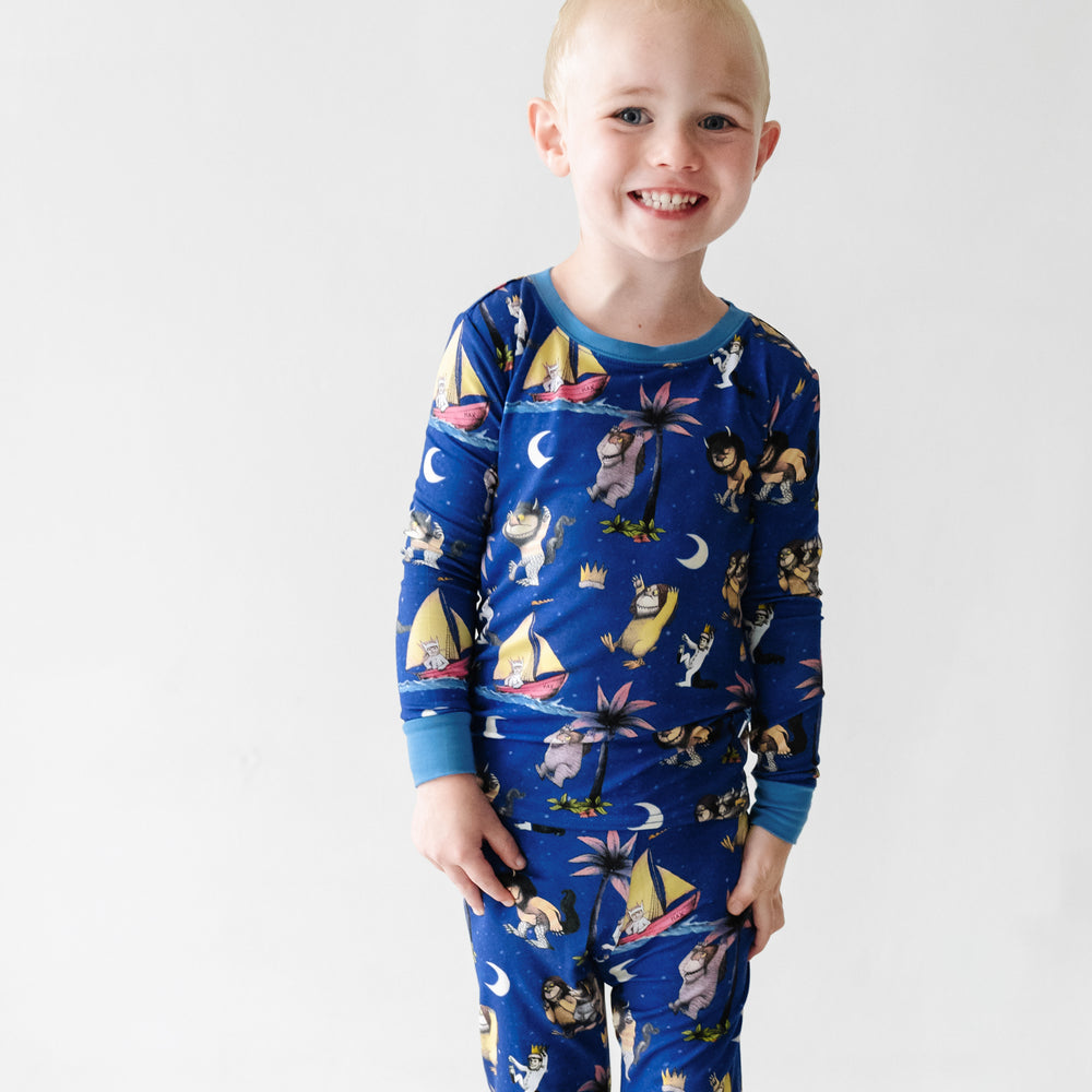 Close up image of a child wearing a Where the Wild Things Are two piece pajama set