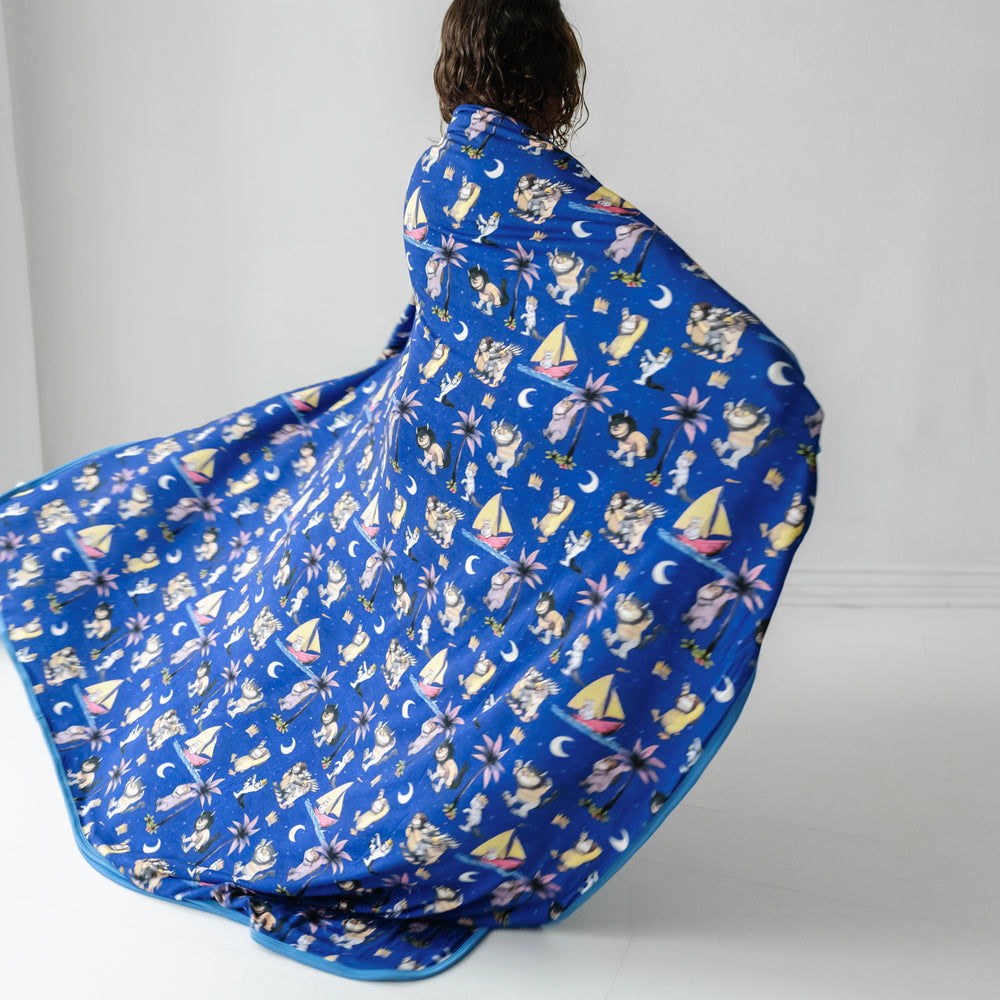 Child twirling in a Where the Wild Things Are cloud blanket