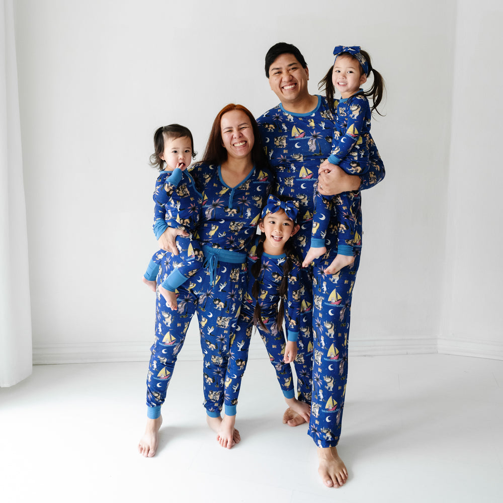 Family of five wearing matching Where the Wild Things Are pajama sets and matching luxe bow headbands 