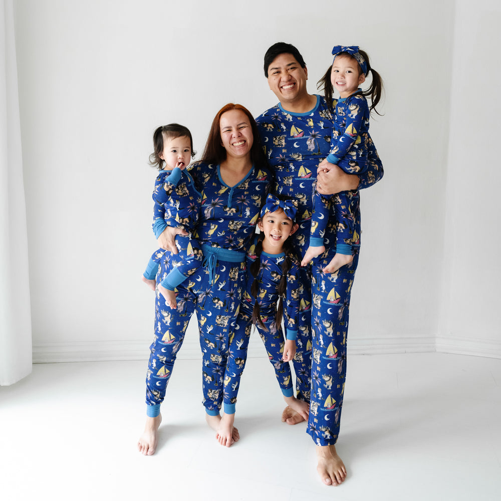 Family of five wearing matching Where the Wild Things Are pajama sets and matching luxe bow headbands