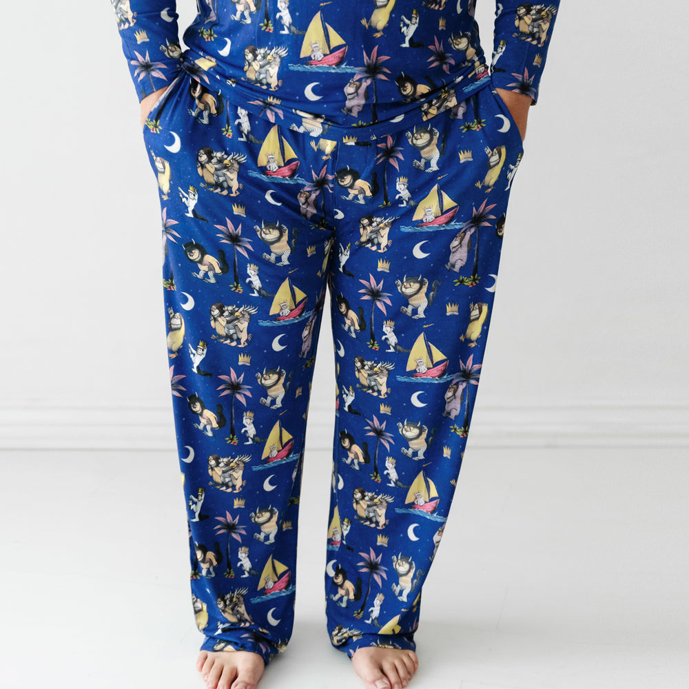 Close up image of a man wearing Where the Wild Things Are men's pajama pants