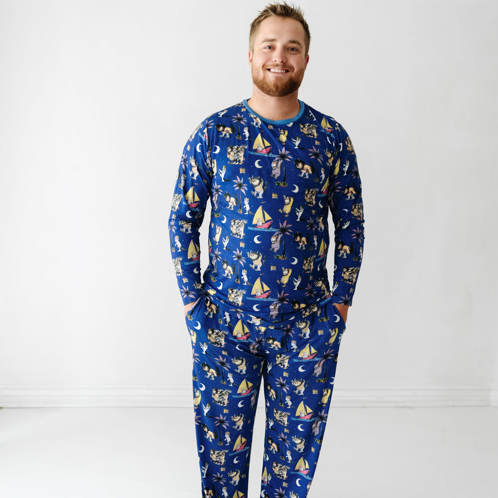 image of a man wearing Where the Wild Things Are men's pajama pants paired with a matching men's pajama top