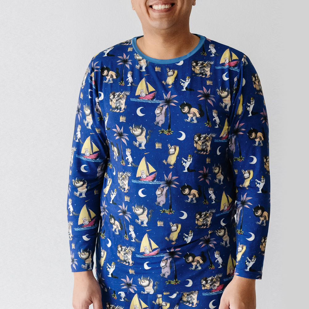 Close up image of a man wearing Where the Wild Things Are men's pajama top