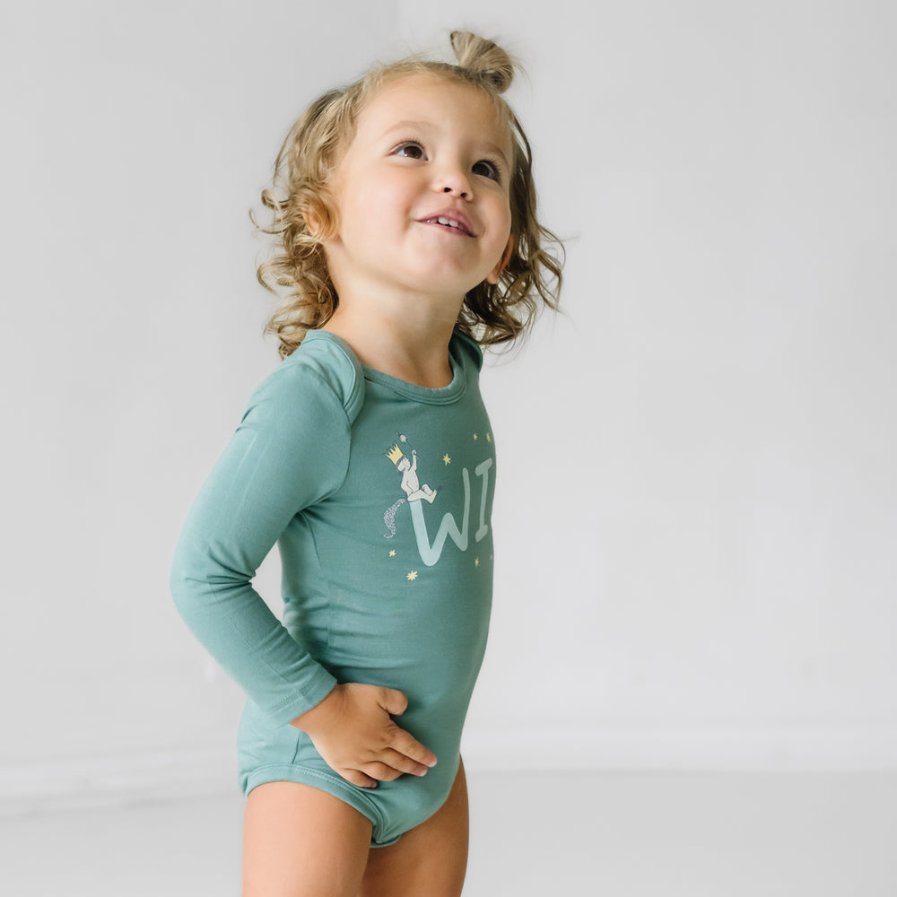 Child posing wearing a Where the Wild Things Are graphic bodysuit