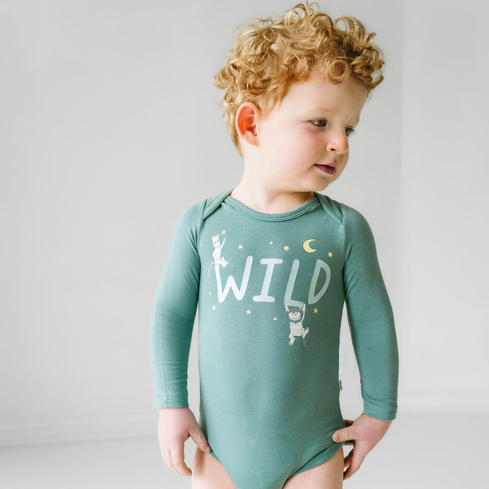Close up image of a child wearing a Where the Wild Things Are graphic bodysuit