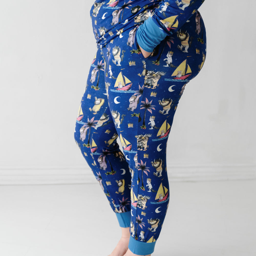 Close up profile image of a woman wearing a Where the Wild Things Are women's pajama pants