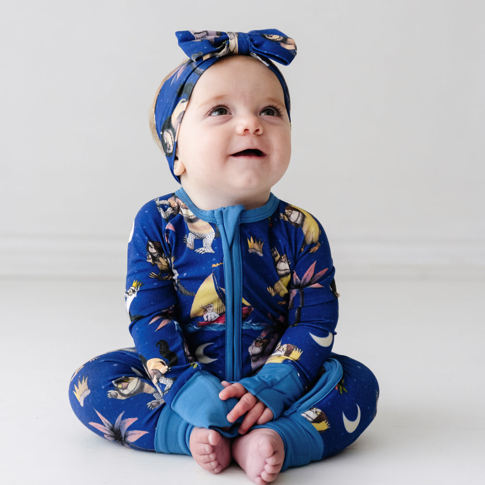 Alternate image of a child sitting wearing a Where The Wild Things Are zippy paired with a matching luxe bow headband