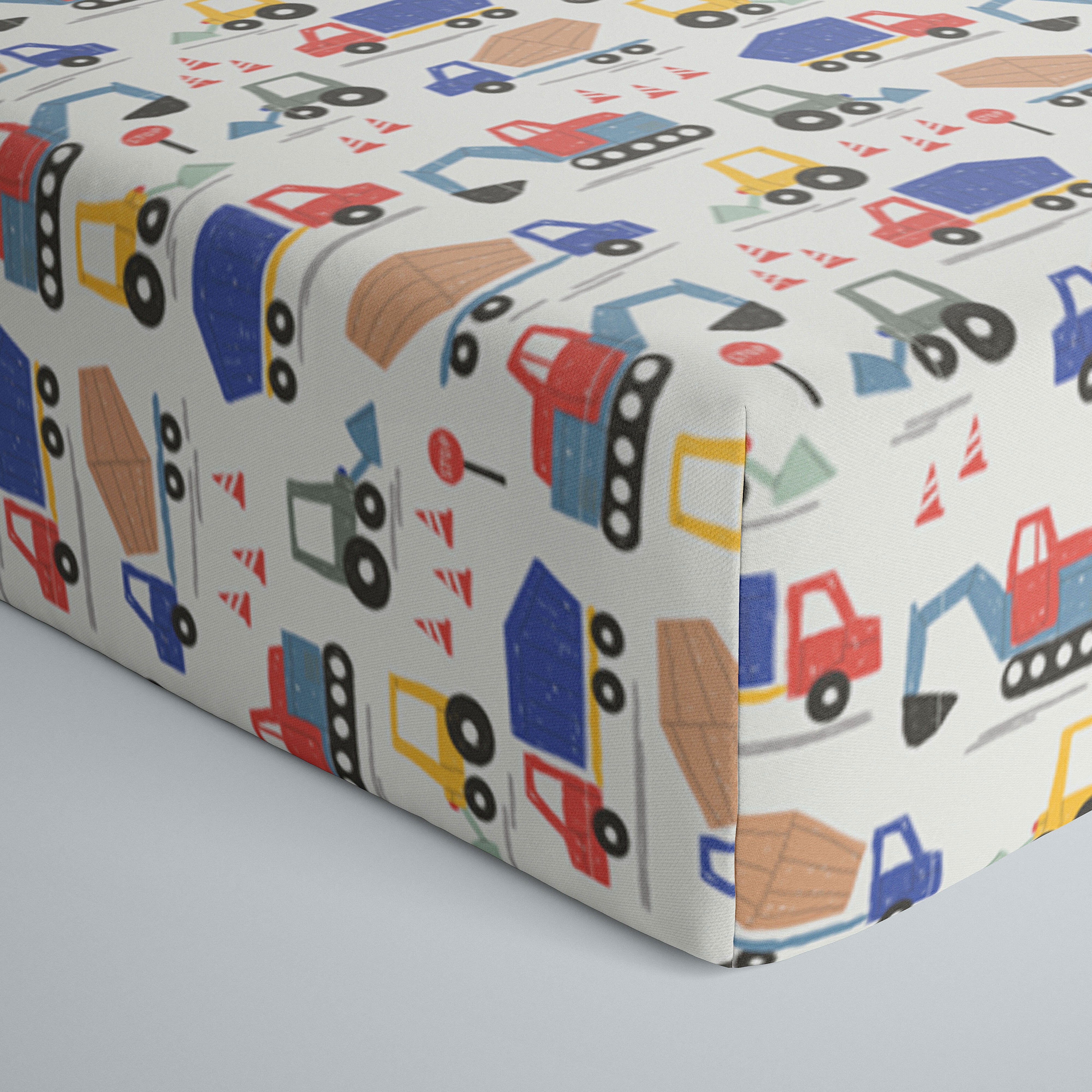 Close up image of infant fitted crib sheet with Construction print