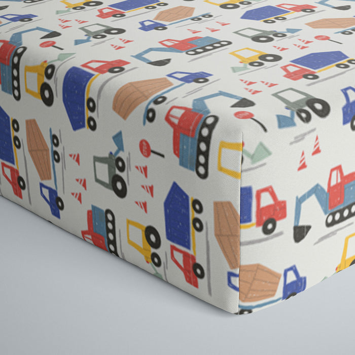 Close up image of infant fitted crib sheet with Construction print
