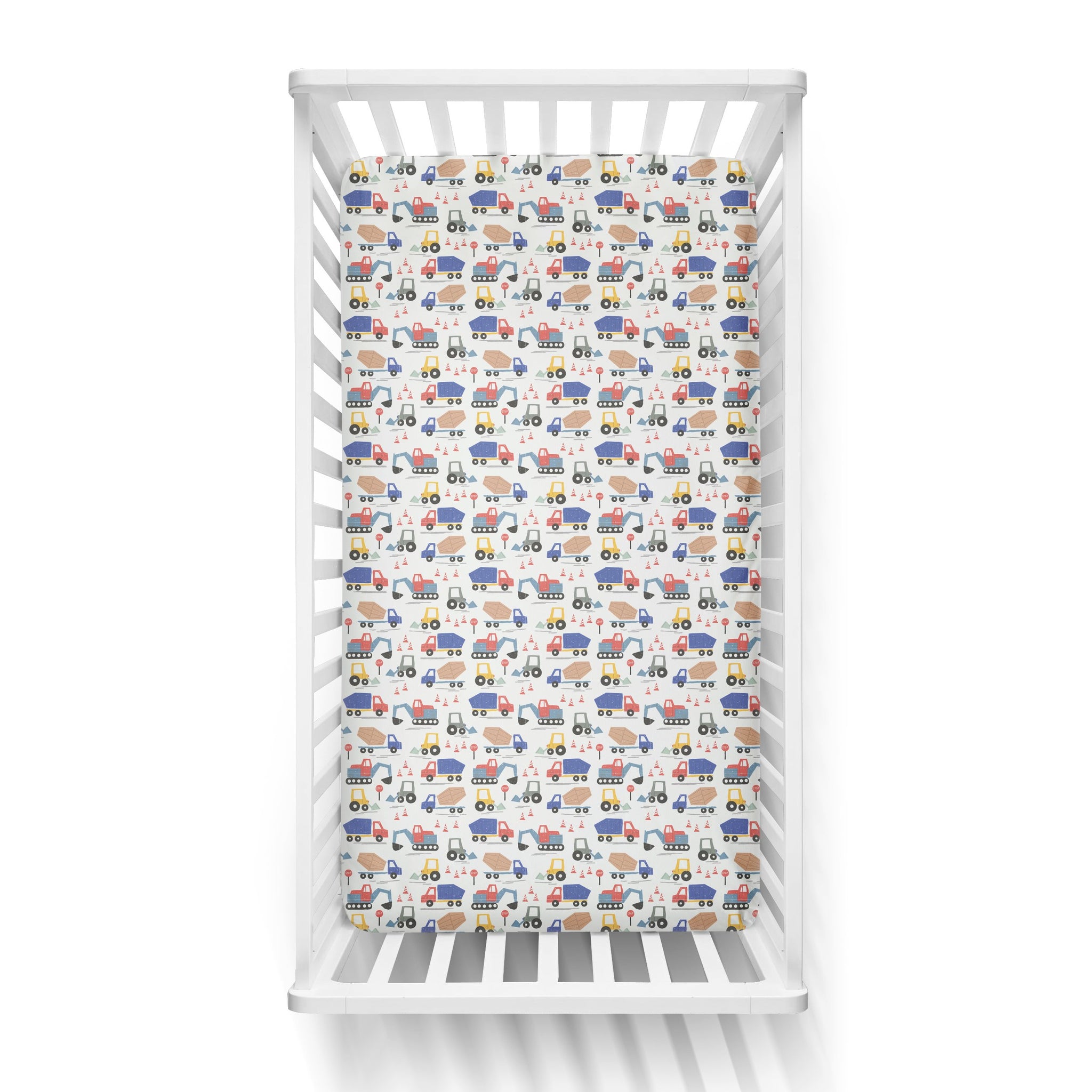 Aerial view of a standard fitted infant crib sheet in Construction print on a white crib