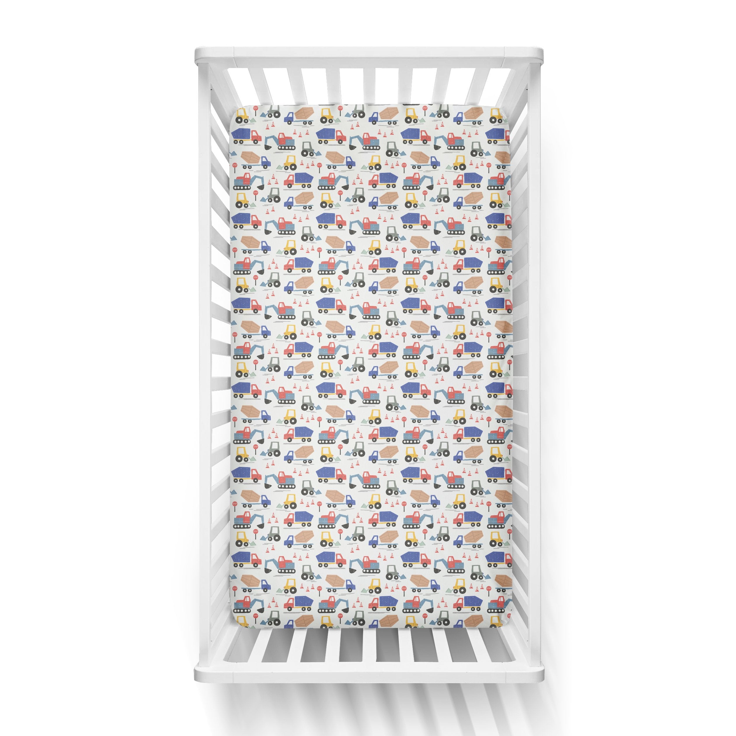 Aerial view of a standard fitted infant crib sheet in Construction print on a white crib