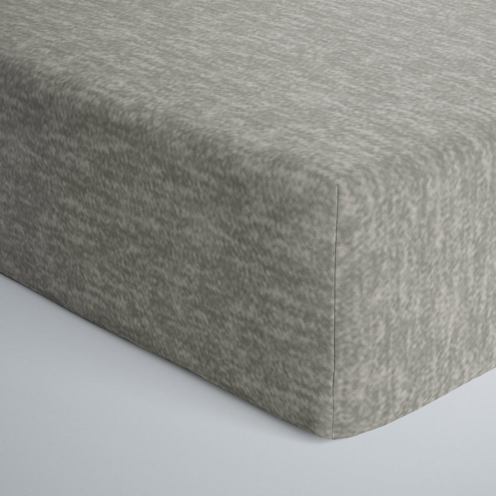 Close up image of infant fitted crib sheet in heather gray. 