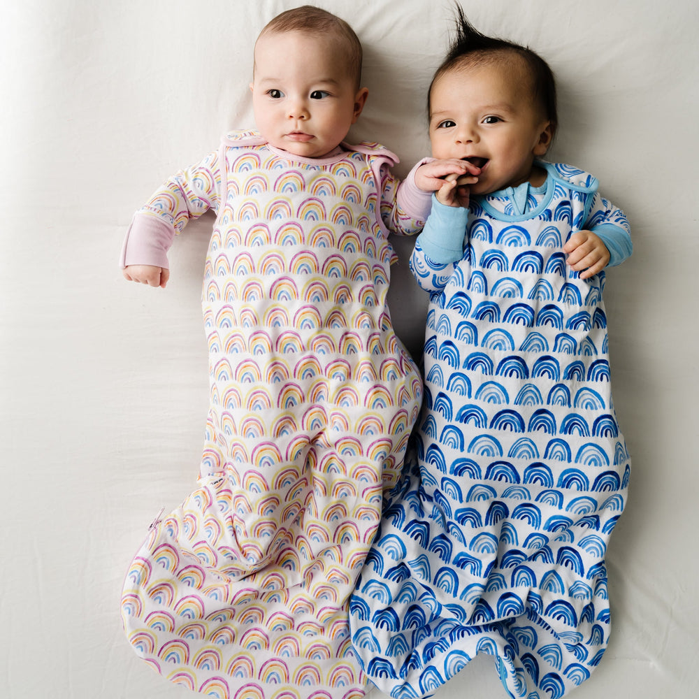 Two infants in a Pastel Rainbows and Blue Rainbows Bamboo Viscose Sleepy Bag/Wearable Blanket
