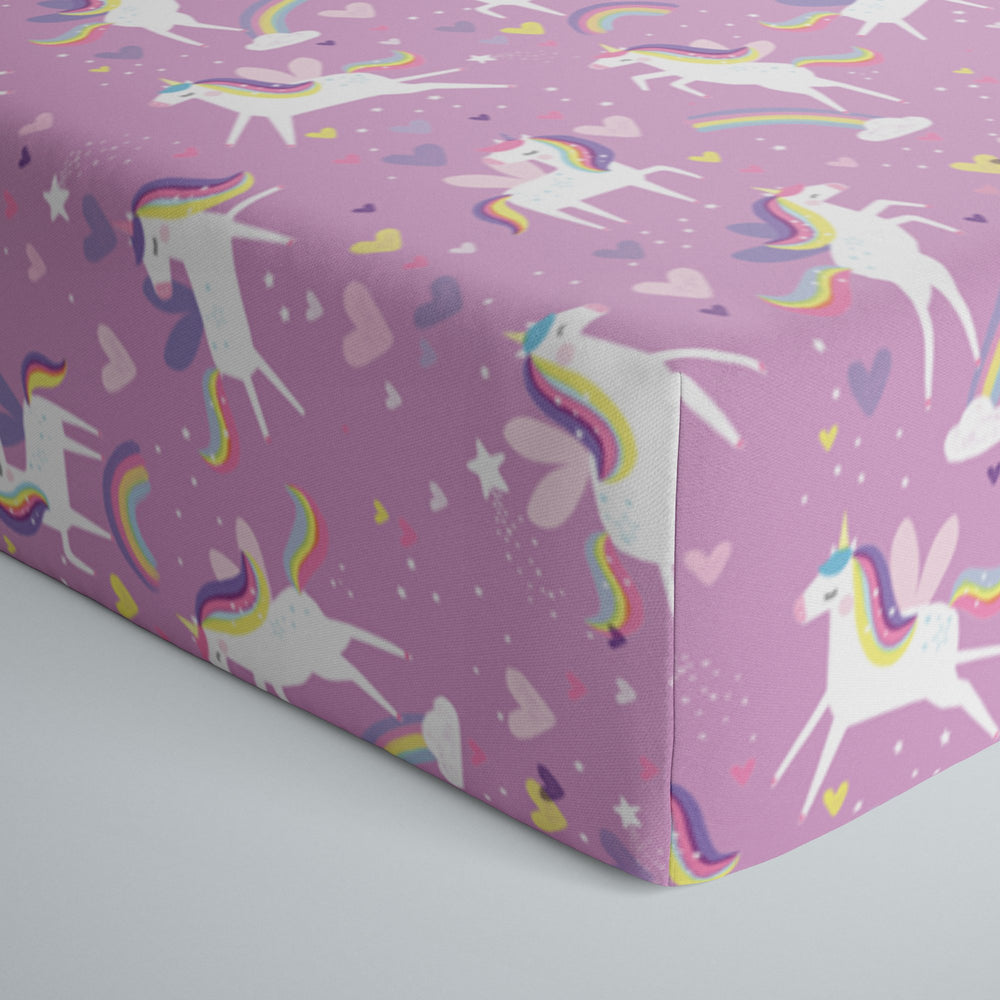 Close up image of infant fitted crib sheet in Sienna's Unicorns print