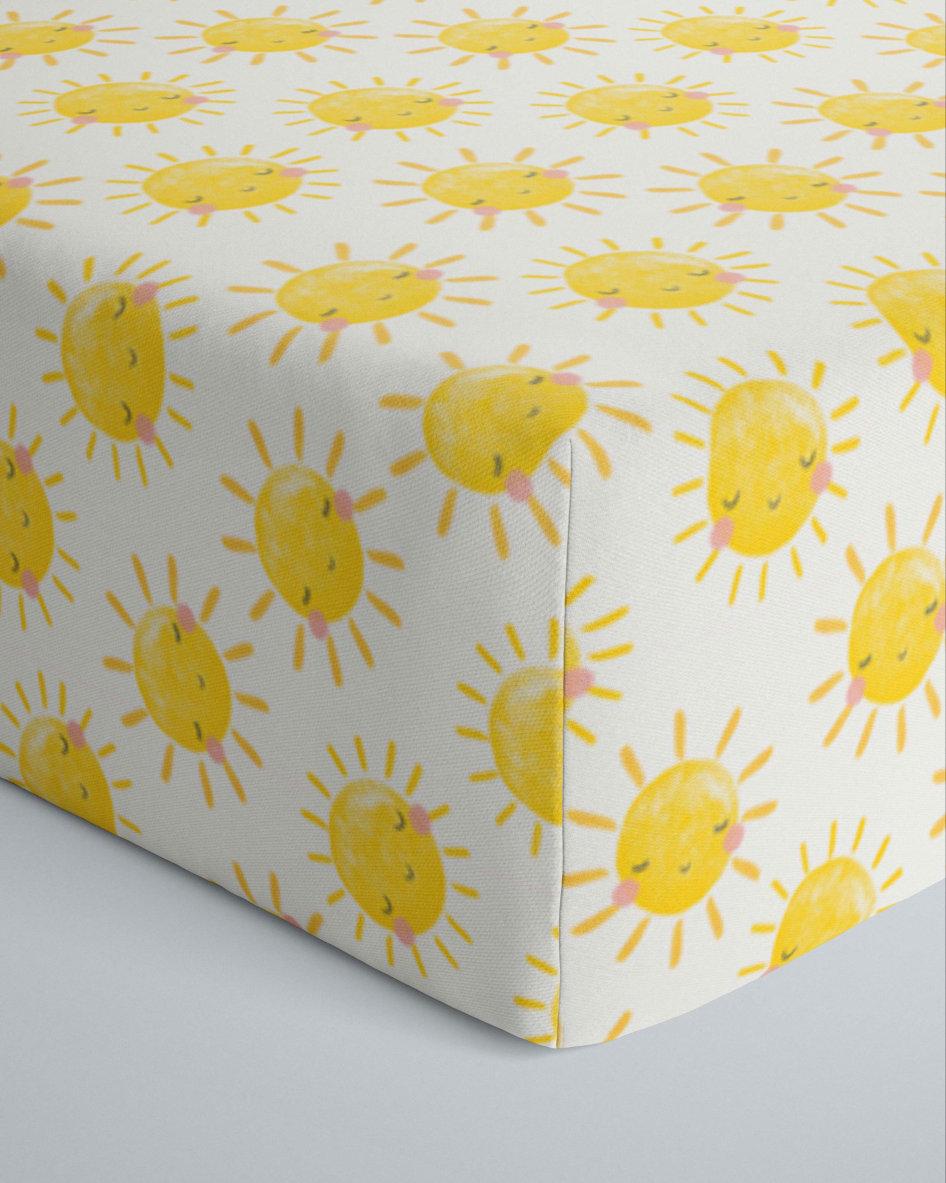 Close up image of infant fitted crib sheet with Yellow smiling sunshines print