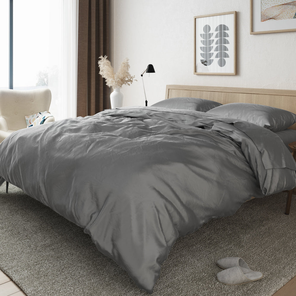 Image of a bedroom with a bed made up with the Bamboo Duvet Cover in Stone.