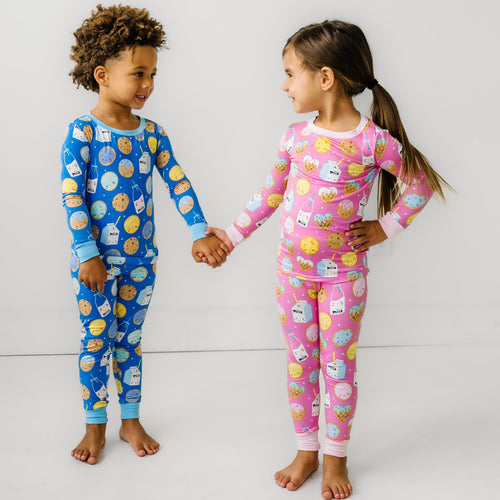 Two children wearing matching Cookies & Milk Two-Piece Pajama Sets