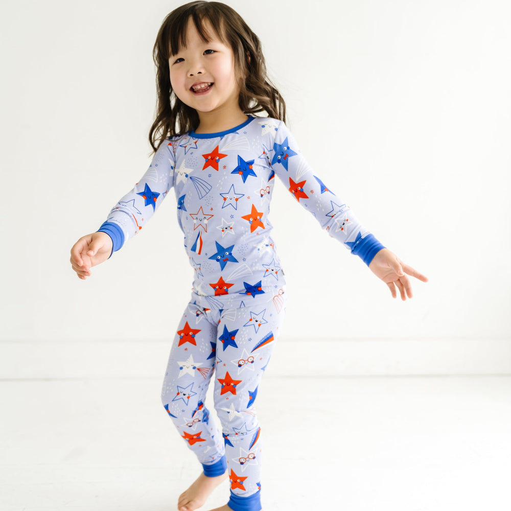 Child dancing wearing a Blue Stars and Stripes printed two piece pajama set