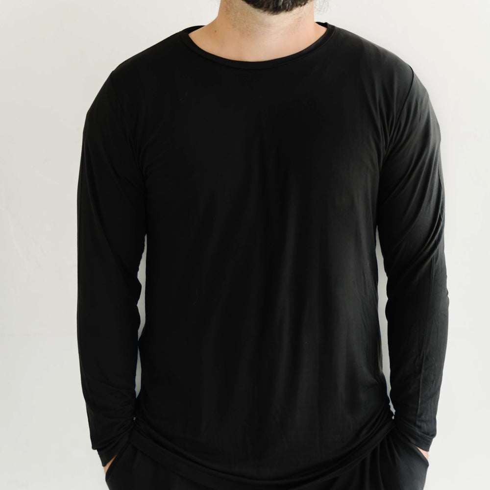 Click to see full screen - Image of male model wearing a solid black long sleeve pajama top